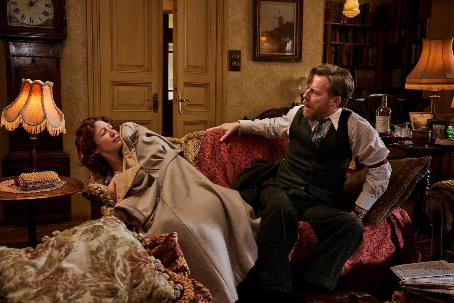 Embarrassing! Caught almost in the act, Siegfried and last night's date Susan struggle awake from beneath a heap of coats and blankets.