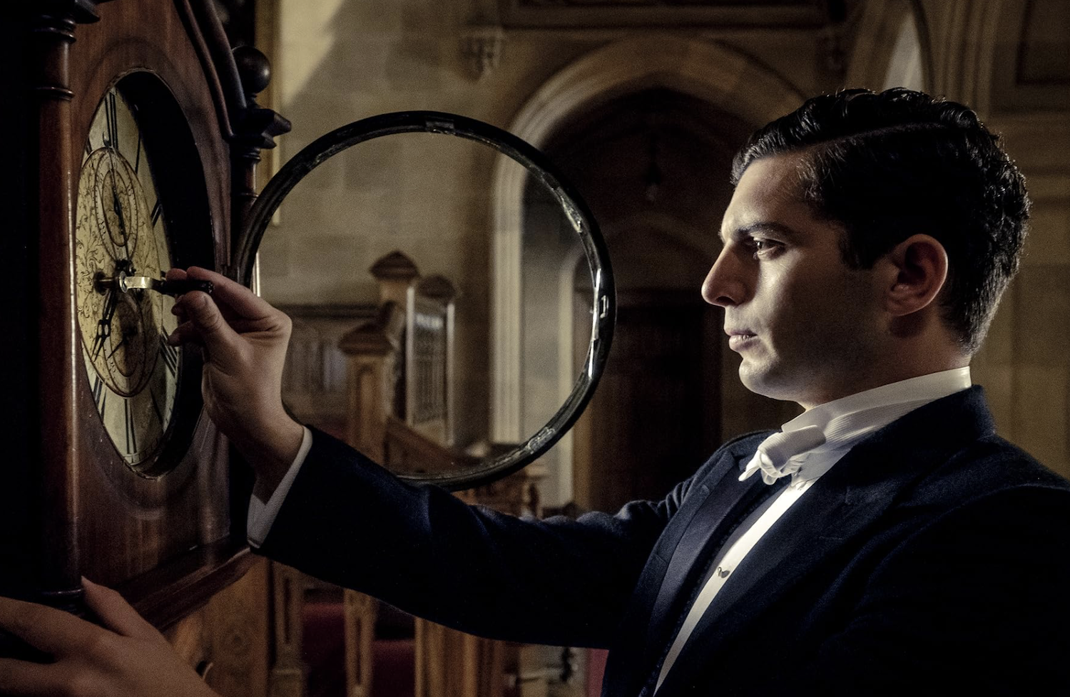 Andy (Michael Fox) winds a Downton Abbey clock.