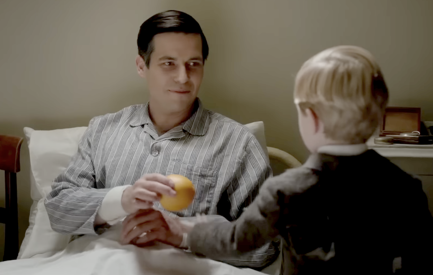 George (uncredited actor) presents Thomas Barrow (Robert-James Collier) with an orange.
