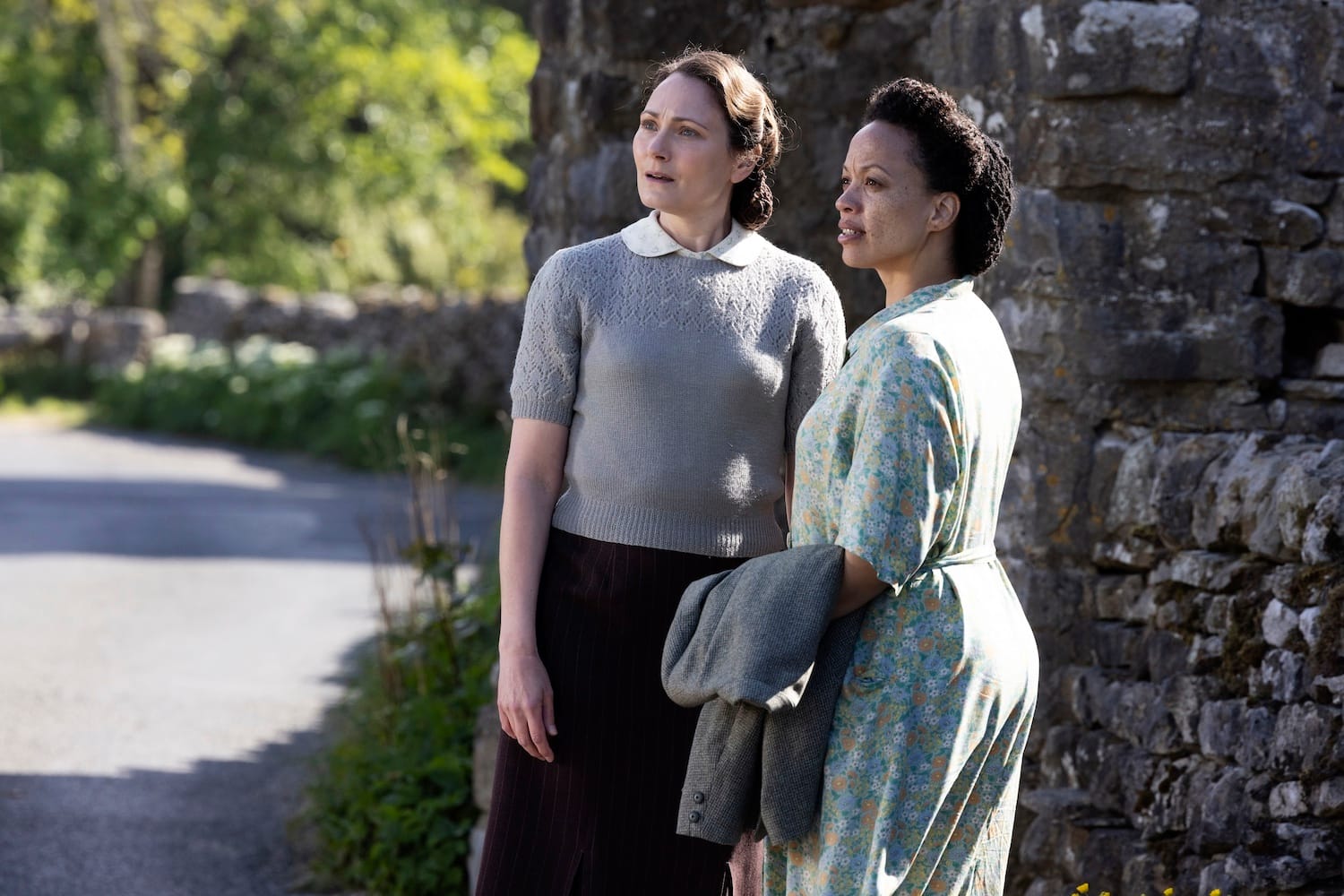 Audrey Hall (Anna Madeley) and Grace Chapman (Cat Simmons) are concerned about Grace's husband Tom. They watch him walk away.