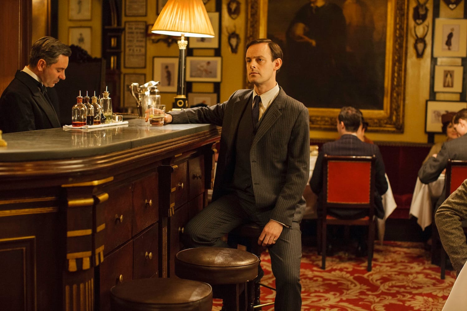 Bertie Pelham (Harry Hadden-Paton) waits at the bar for Edith.