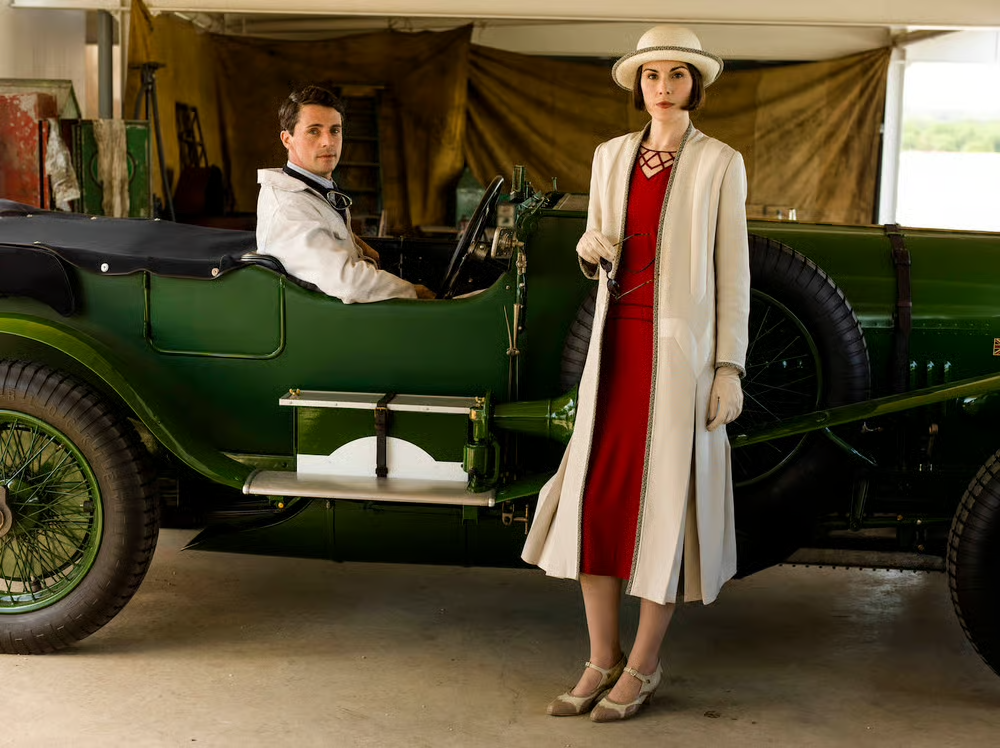 Lady Mary (Michelle Dockery) and Henry Talbot (Matthew Goode) and his cute car.