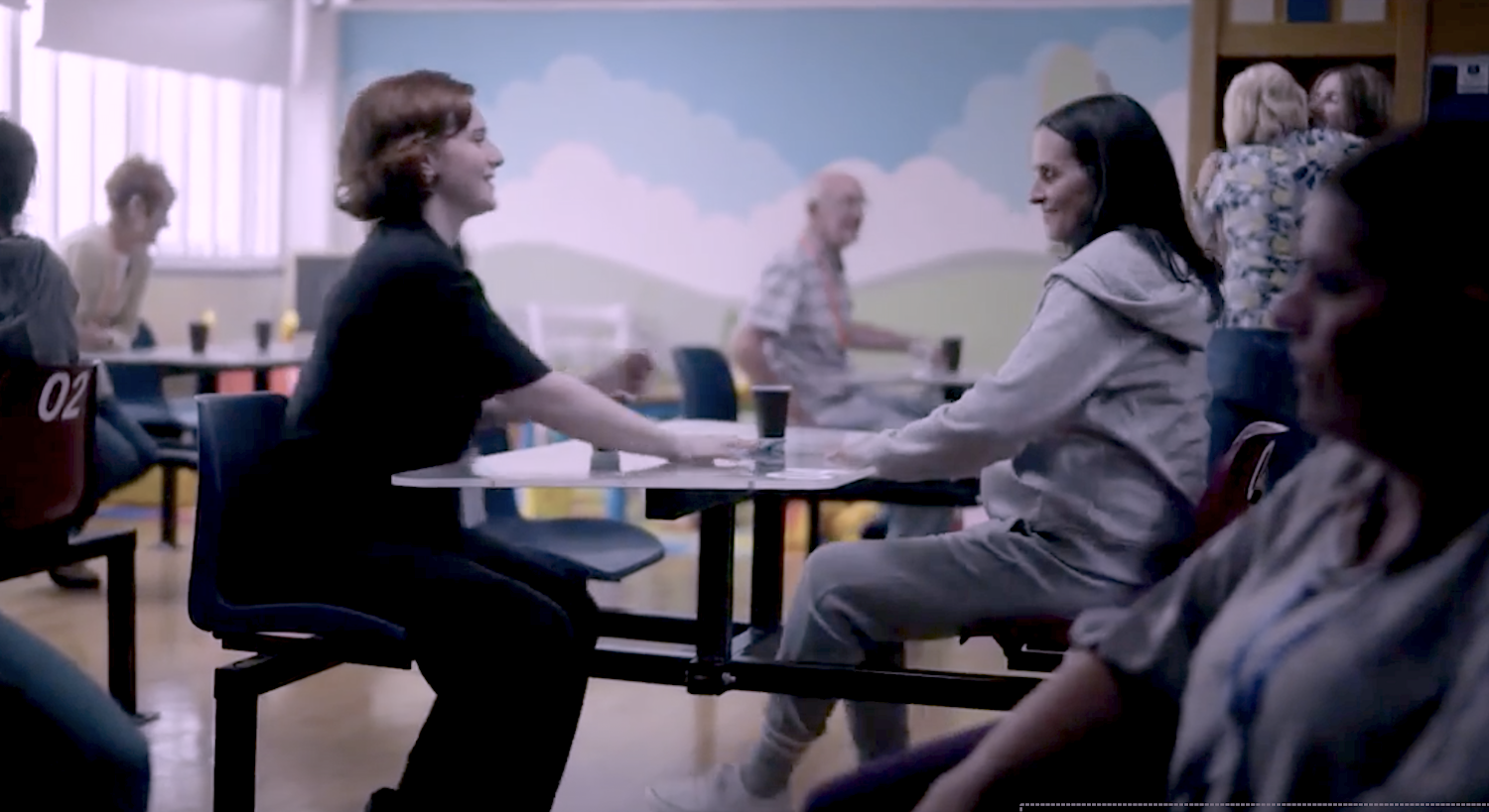 Diana (Hannah Onslow) and her mother Lesley (Leanne Best) share an affectionate moment sitting at a table on the prison visit