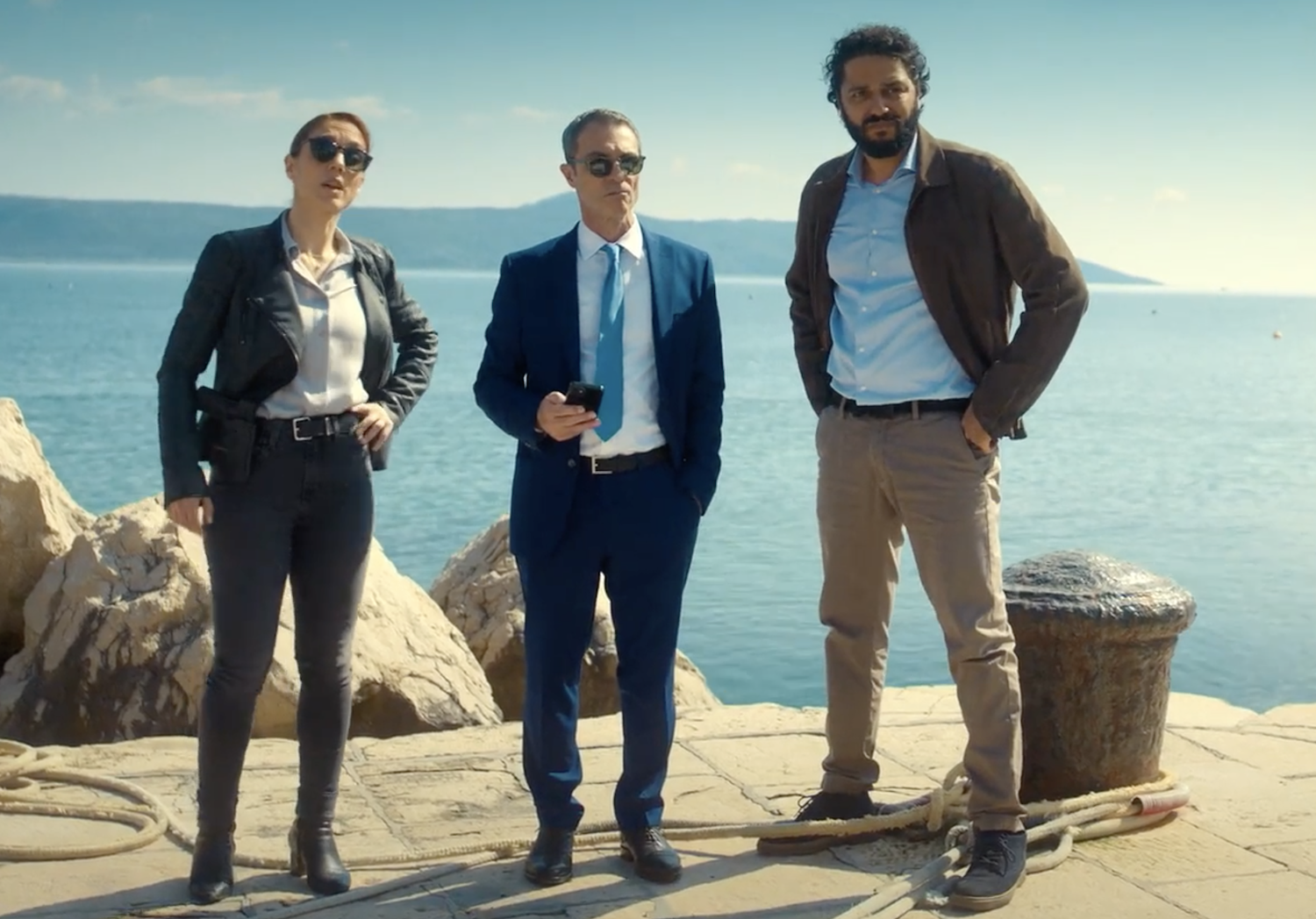 Inspector Lara Sarrancino (Cristiana Dell’Anna), Commissario Curti (Pasquale Esposito), and Deputy Inspector Fianni Gallo (Marouane Zotti) at the harbor, watch as the second body is brought ashore.