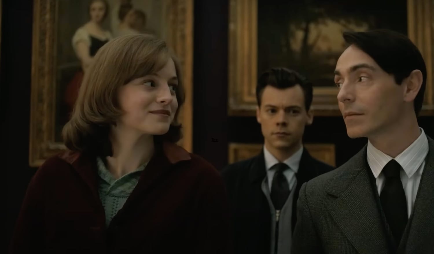 Marion (Emma Corrin) and Patrick (David Dawson) bond as he shares his expertise on art, while Tom (Harry Styles) looks on.