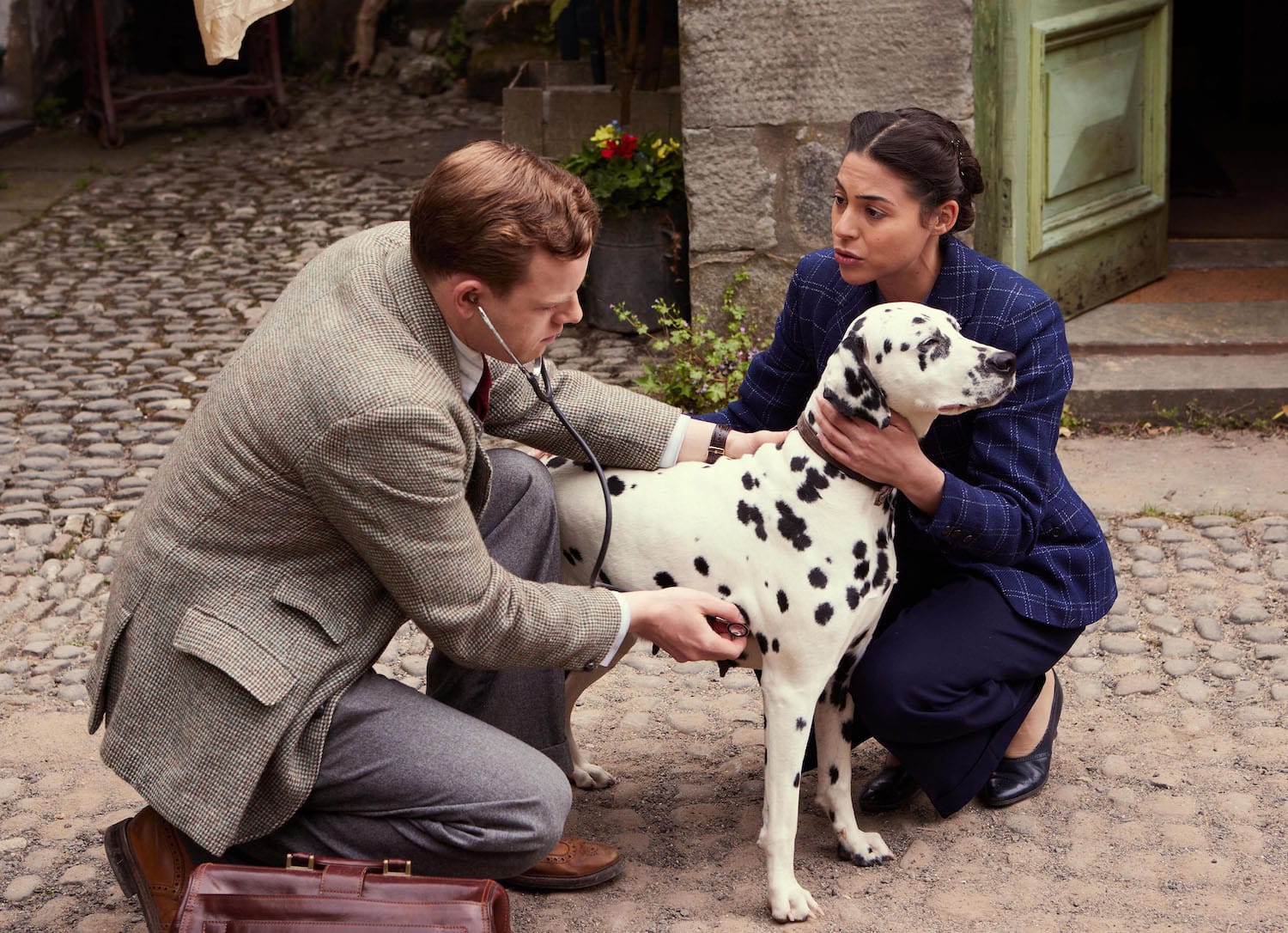 Nice dog, annoying woman. A grumpy Tristan Farnon (Callum Woodhouse) examines Florence Pandhi's (Sophie Khan Levy) dog.