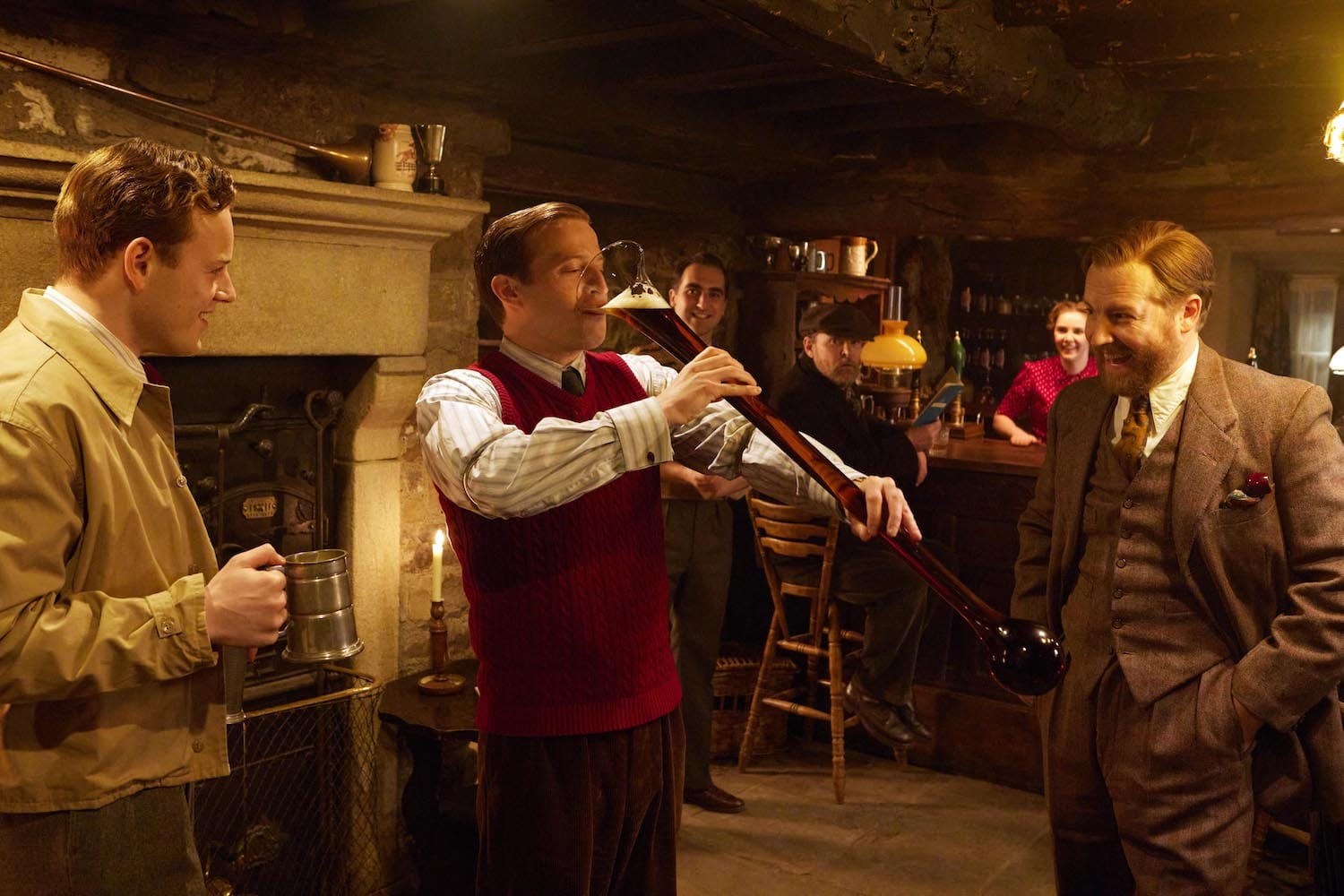 In the pub on his stag night, James (Nicholas Ralph) chugs a yard of ale encouraged by Tristan (Callum Woodhouse) and Siegfried (Samuel West).