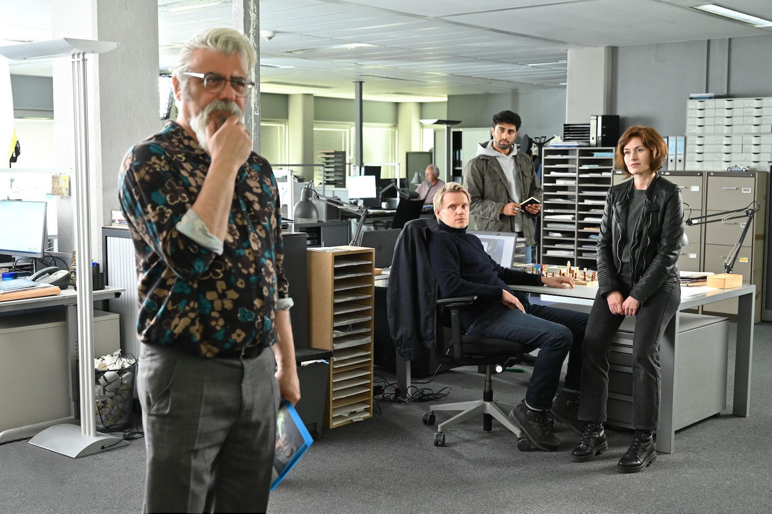 Pathologist Hendrik Davie (Darrel D'Silva), Piet Van der Valk (Marc Warren), Eddie Suleman (Azan Ahmed), and Lucienne Hassell (Mamie McCoy).
