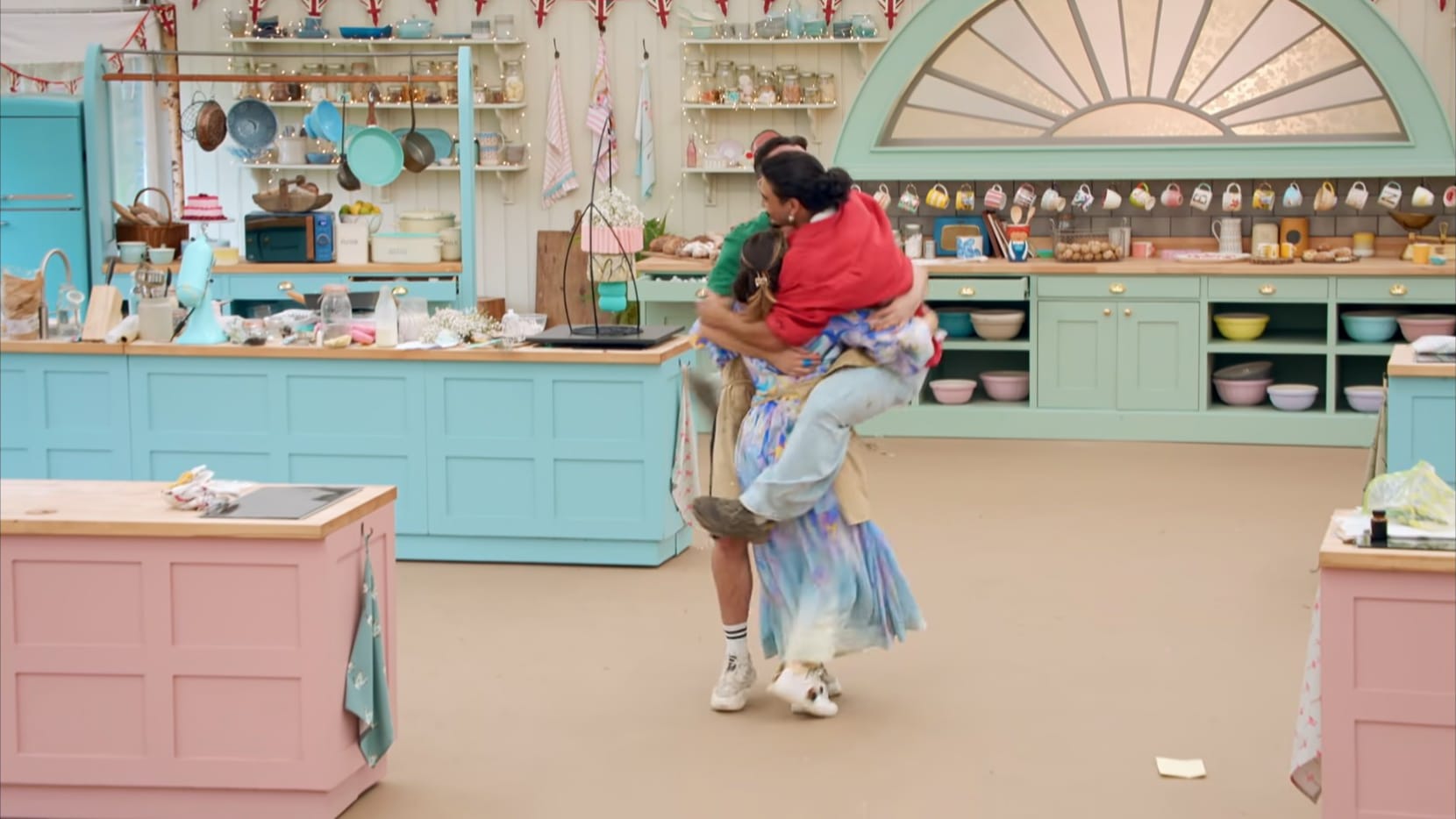 Dylan jumps on Georgie and Christiaan at the conclusion of The Great British Baking Show Season 15's final challenge