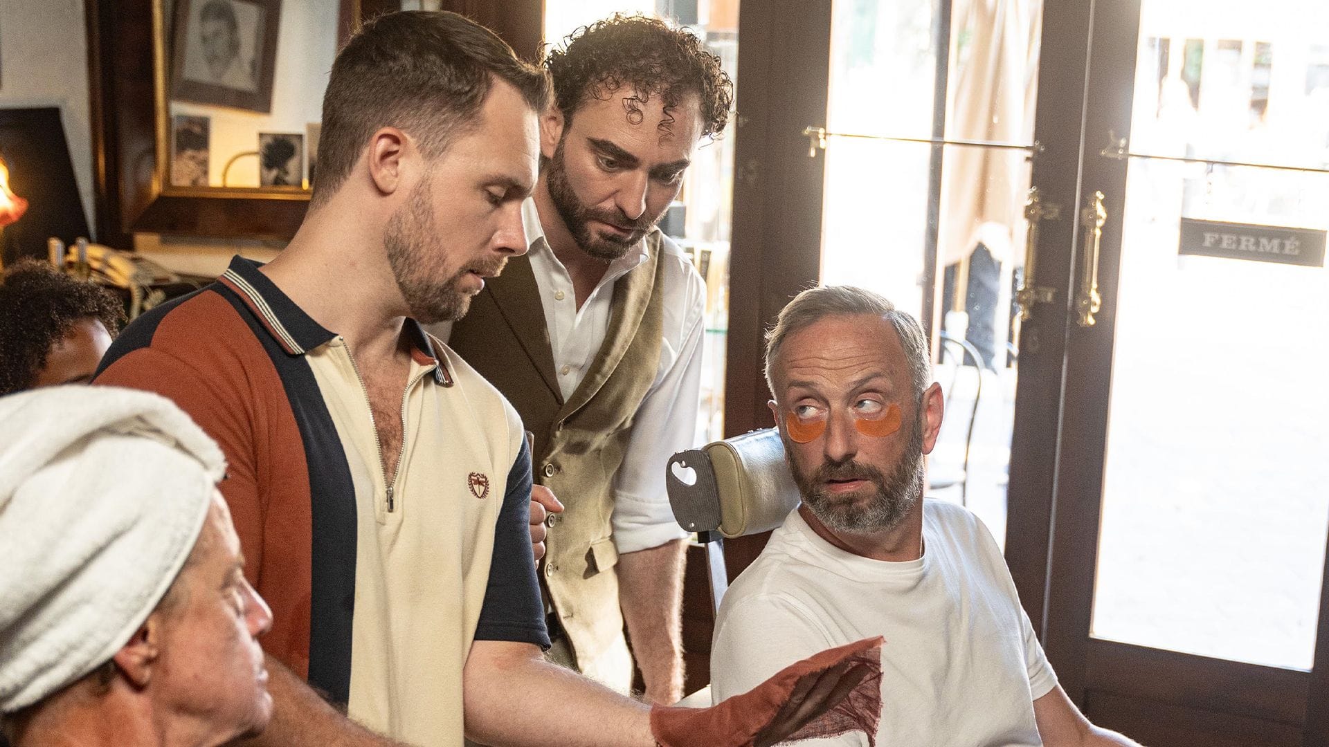 Danny Hatchard (Jovan Smith) shows his treasure to Jeremy Lloyd-James (Robin Askwith), barbershop proprietor Vinnie (Atilla Akinci) and Dom (Steve Edge).&nbsp;