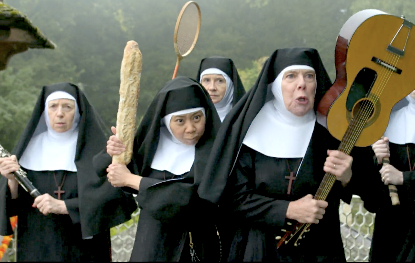 Sister Peter (Tina Chang) armed with a baguette, and Sister Laurence (Kate Robbins) wielding a guitar, lead a group of nuns to save Sister Boniface.